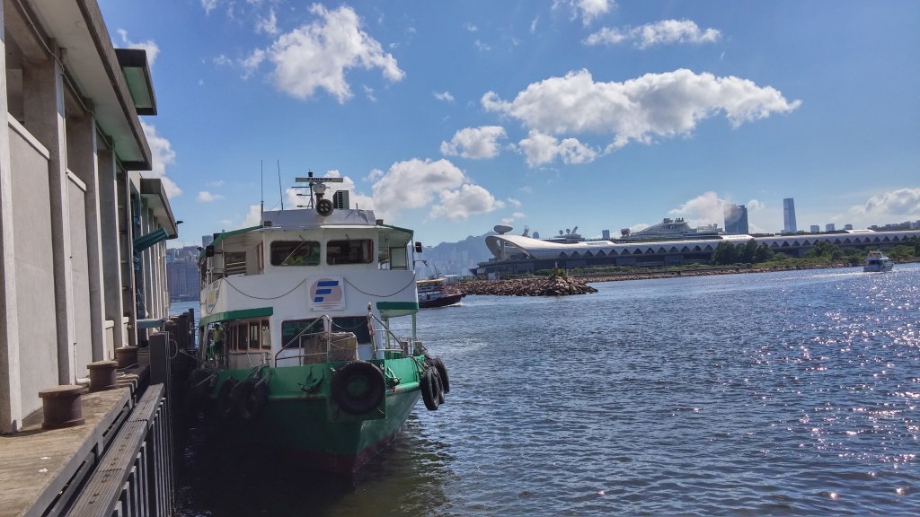 Under good weather, ferry berthing at pier, backdrop is Kai Tak Cruise Terminal