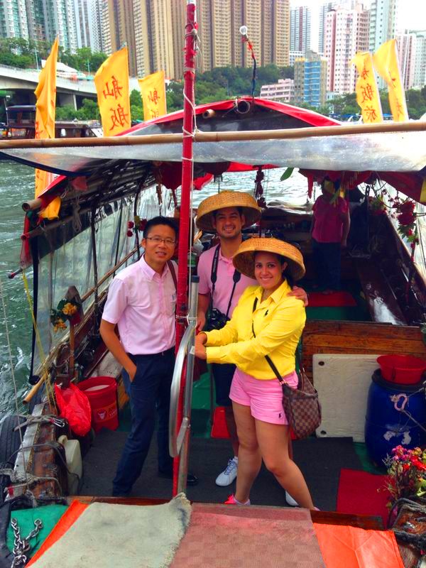 Frank the tour guide with honeymooner during sampan ride at Aberdeen