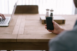 person-smartphone-office-table