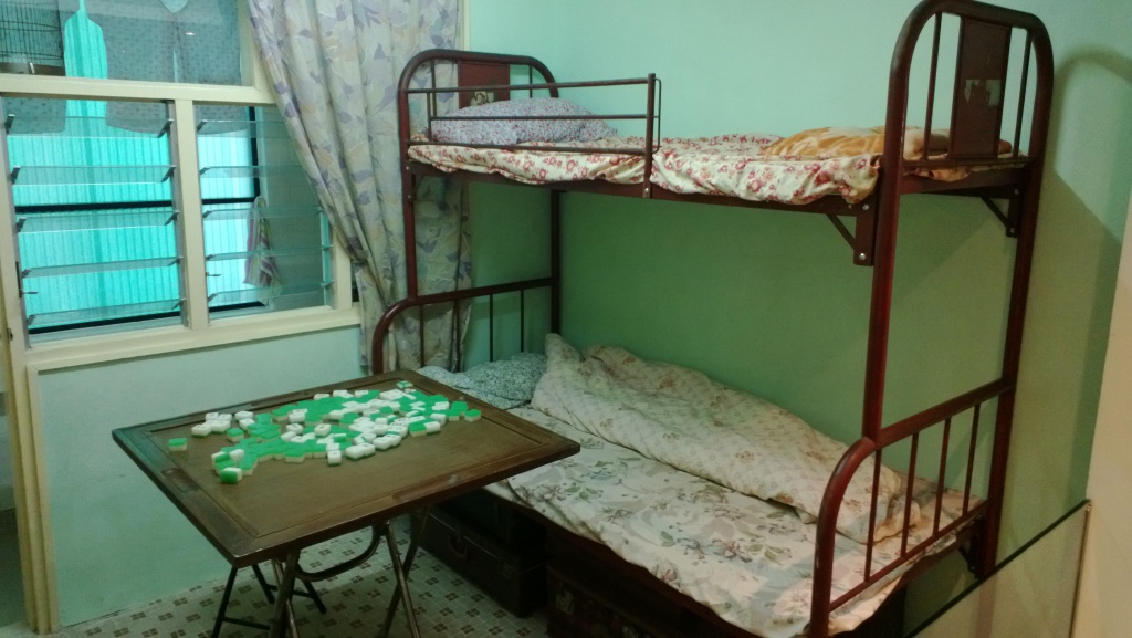 Bedroom with mahjong table at Mei Ho House apartment