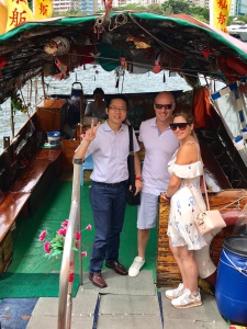 Frank the tour guide takes photo with guests after the sampan ride at Aberdeen