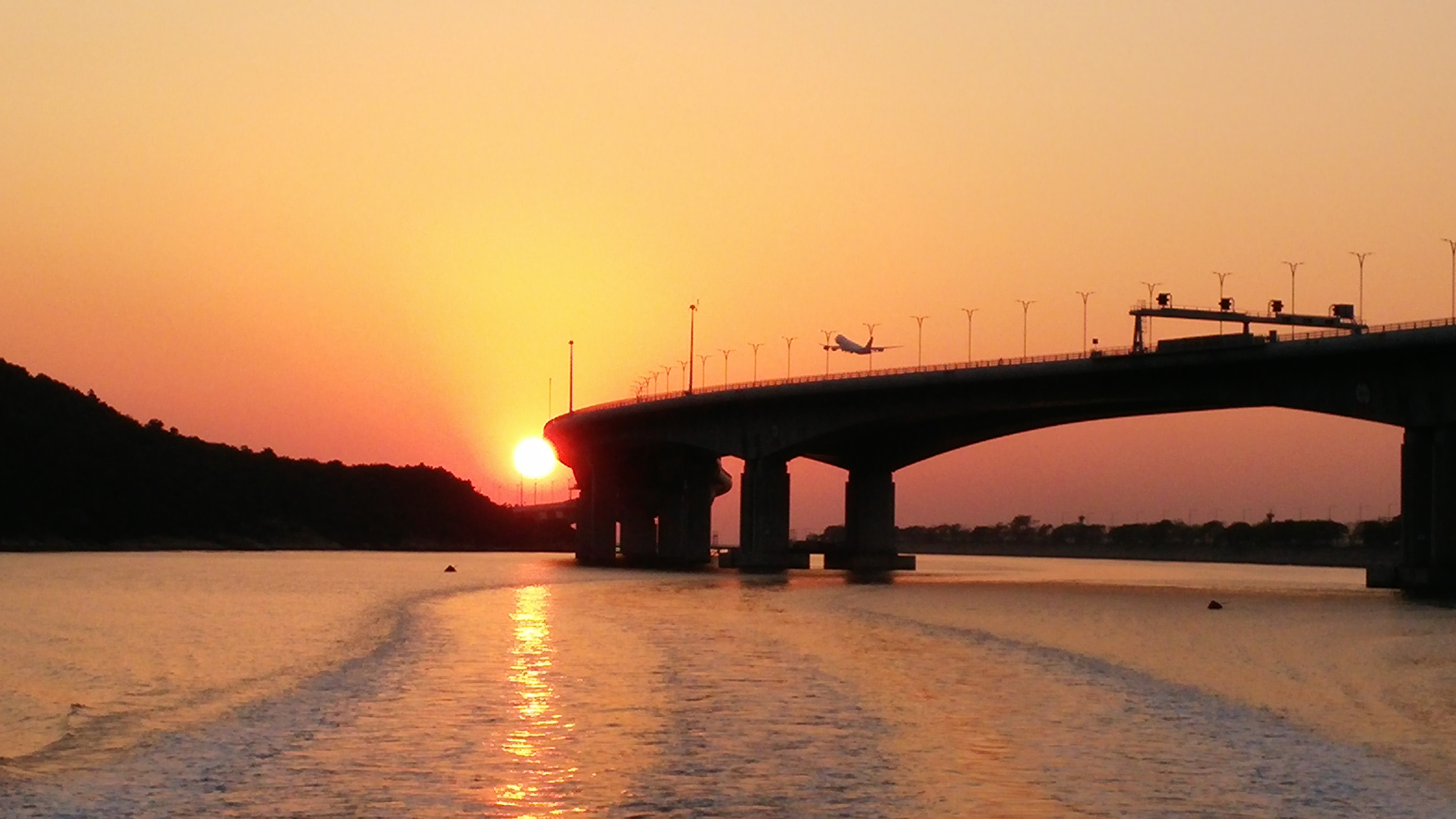 See Hong Kong Macau Zhuhai Bridge, sunset and flight takes off during Tai O to Tung Chung Ferry ride