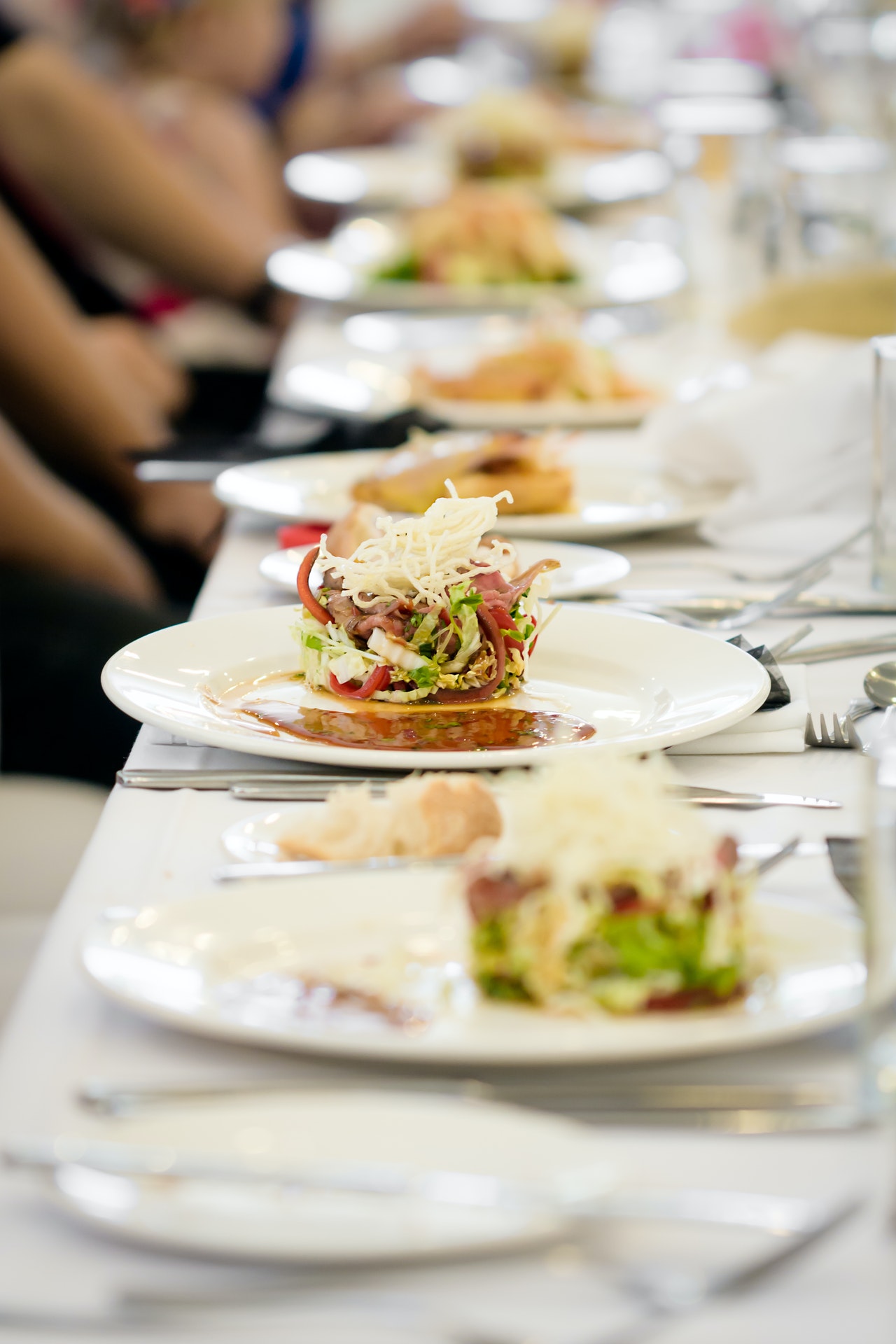 long table, different dishes, diners