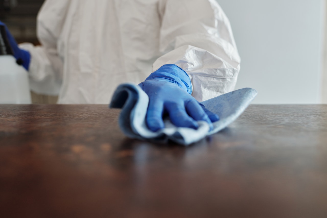 white protective vet, blue plastic glove, cloth, cleaning