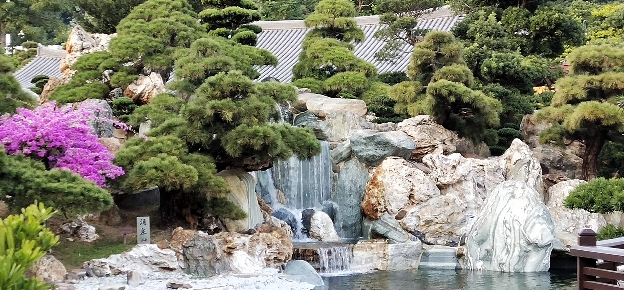 trees, rocks, small waterfall, wooden building