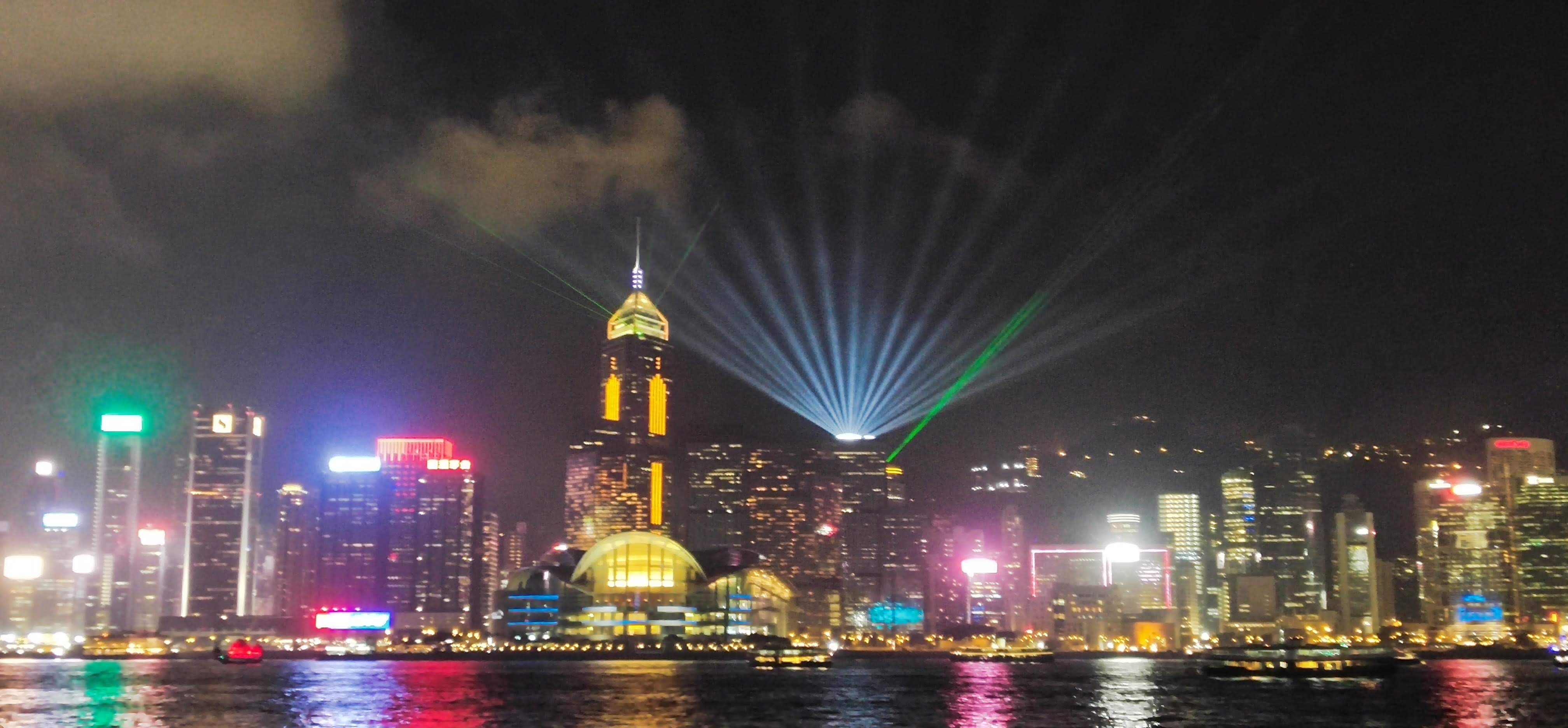 laser show, skyscrapers harbor, nighttime