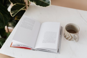 open-book-and-cup-of-coffee-on-table