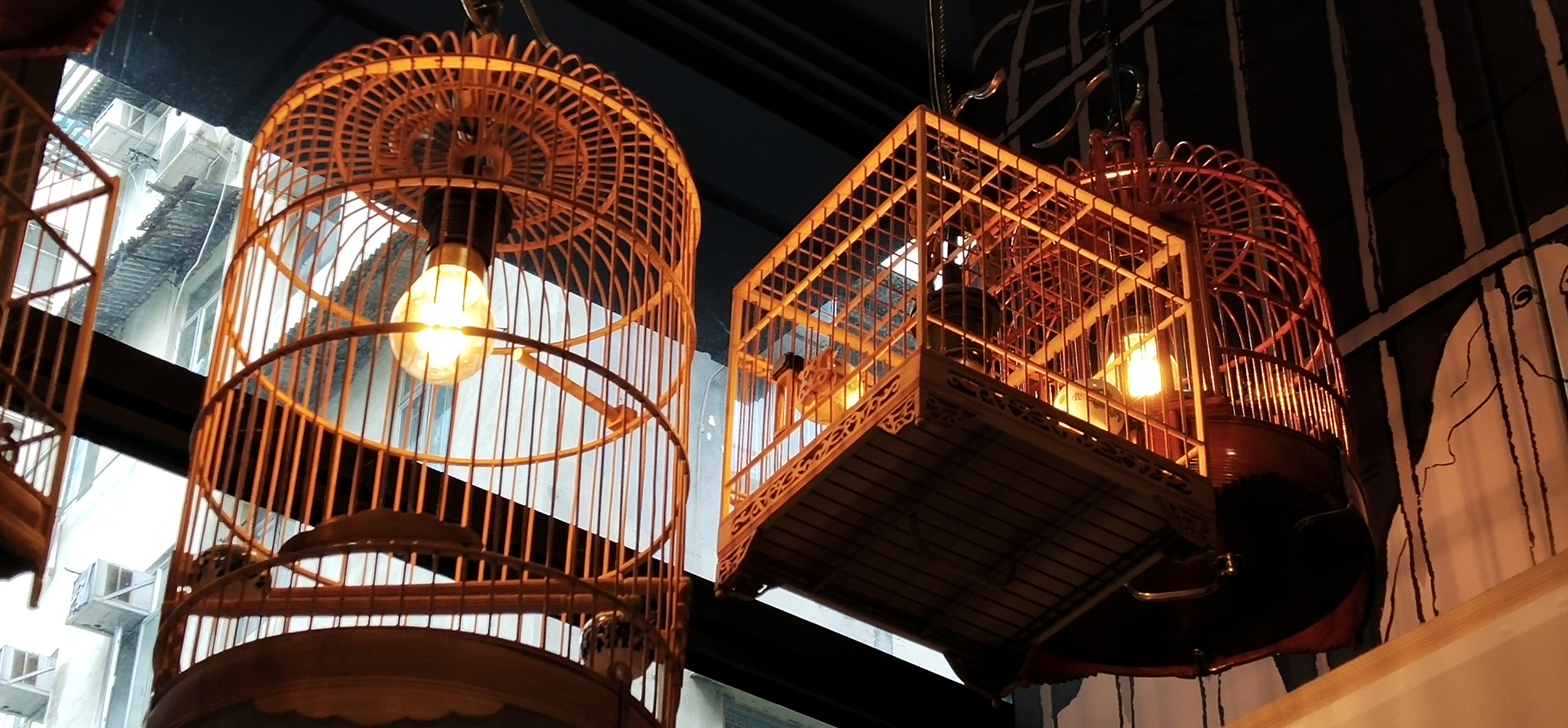 Art work shows bird cages in restaurant in the past