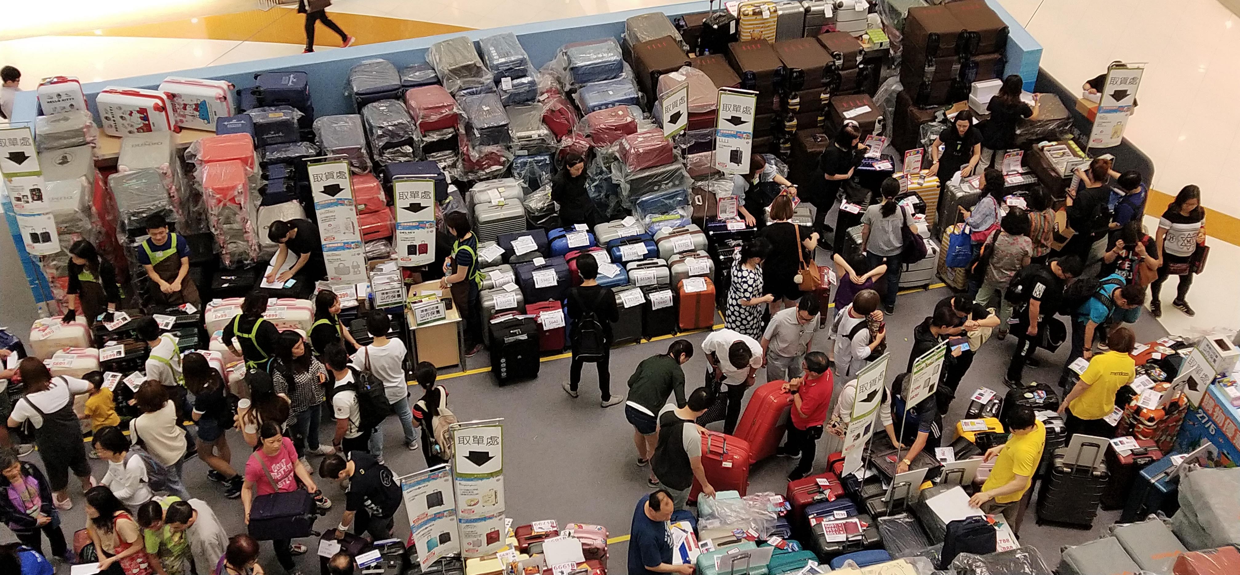 shopper buying suitcase, shopkeepers selling suitcase