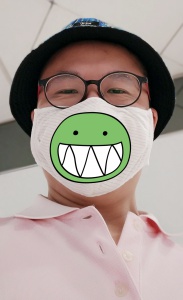 Frank the tour guide wears mask with a green smiling emoji