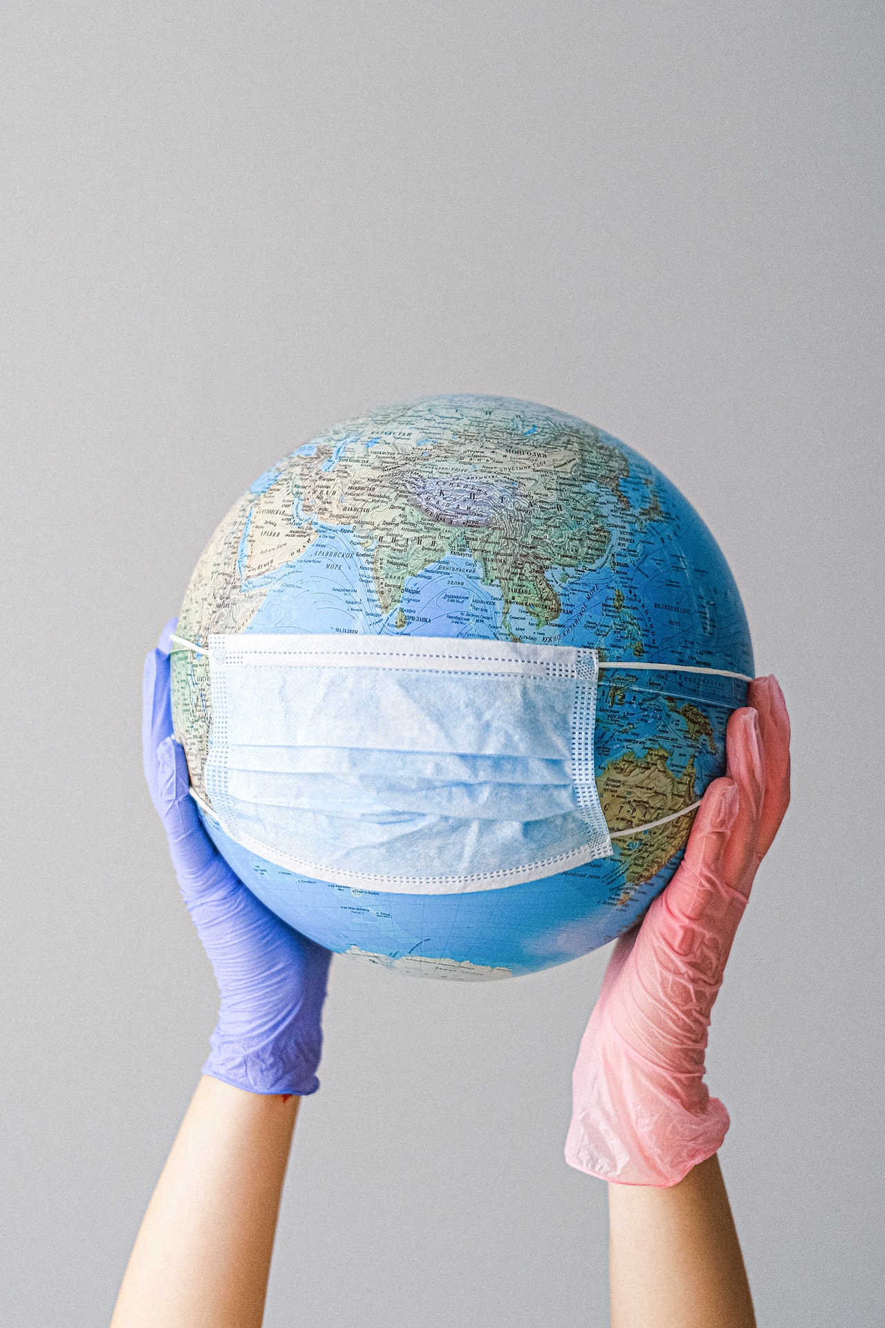 globe covered by white face mask