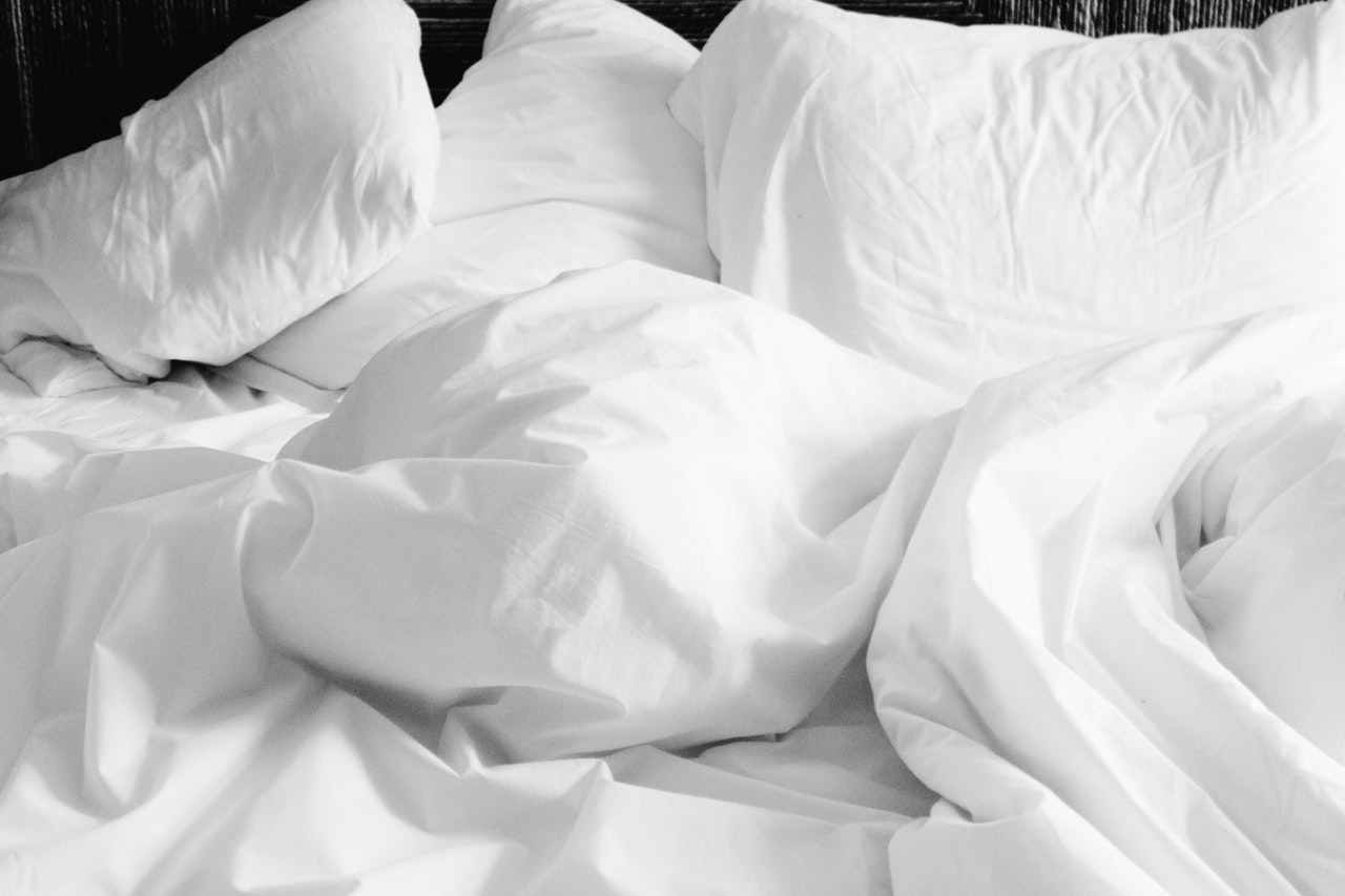 bed with white pillow, white blanket