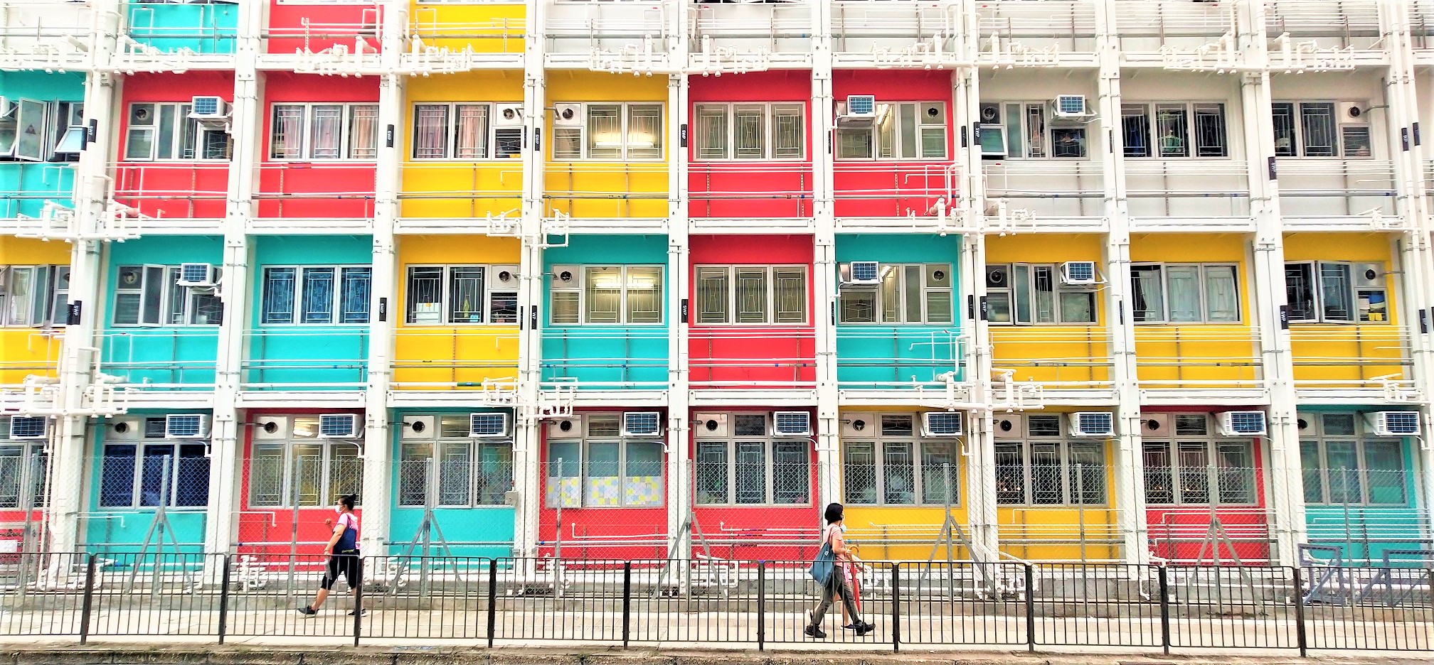 A colorful new transitional housing block shows Western travelers Chinese idiom and Hong Kong old saying 