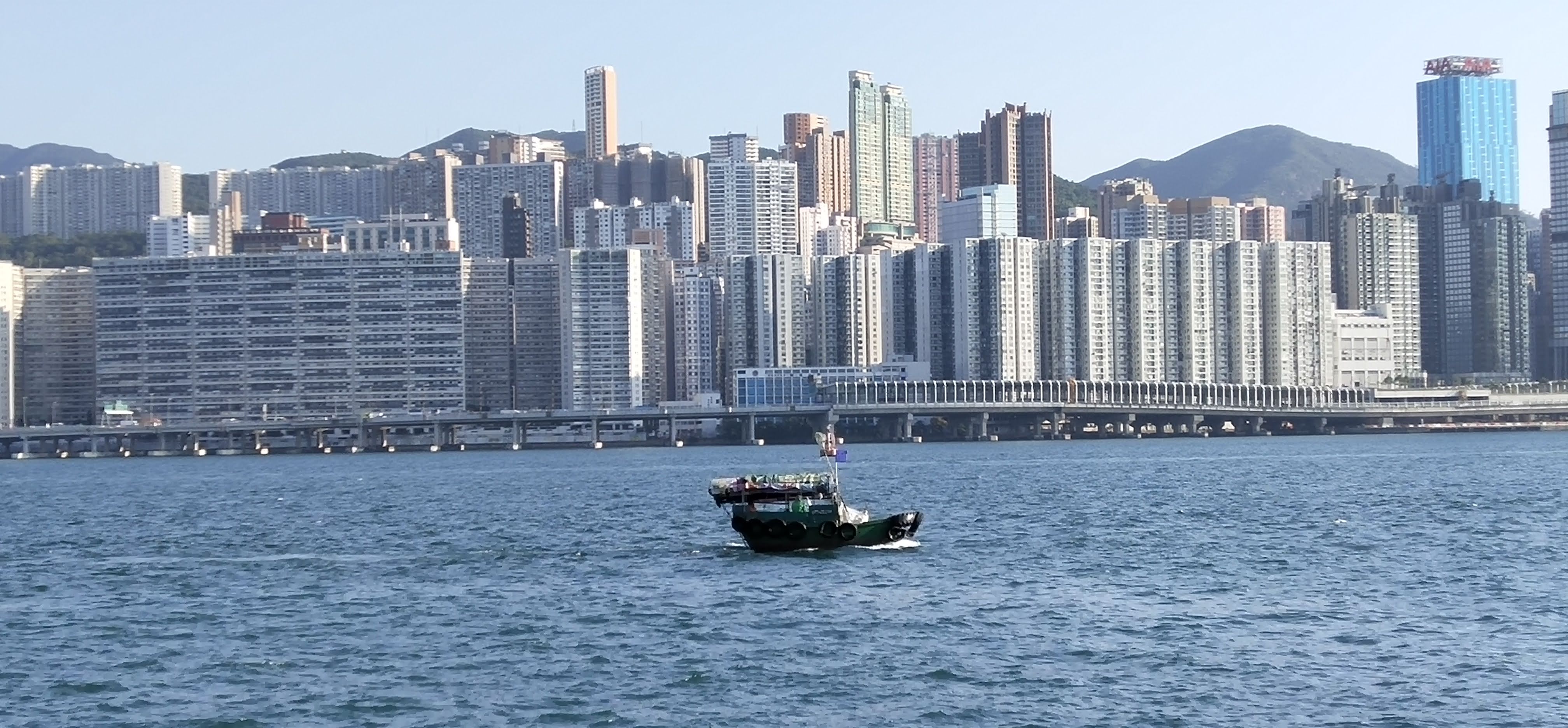 Sampan boat in quiet Victoria Harbor under Covid-19