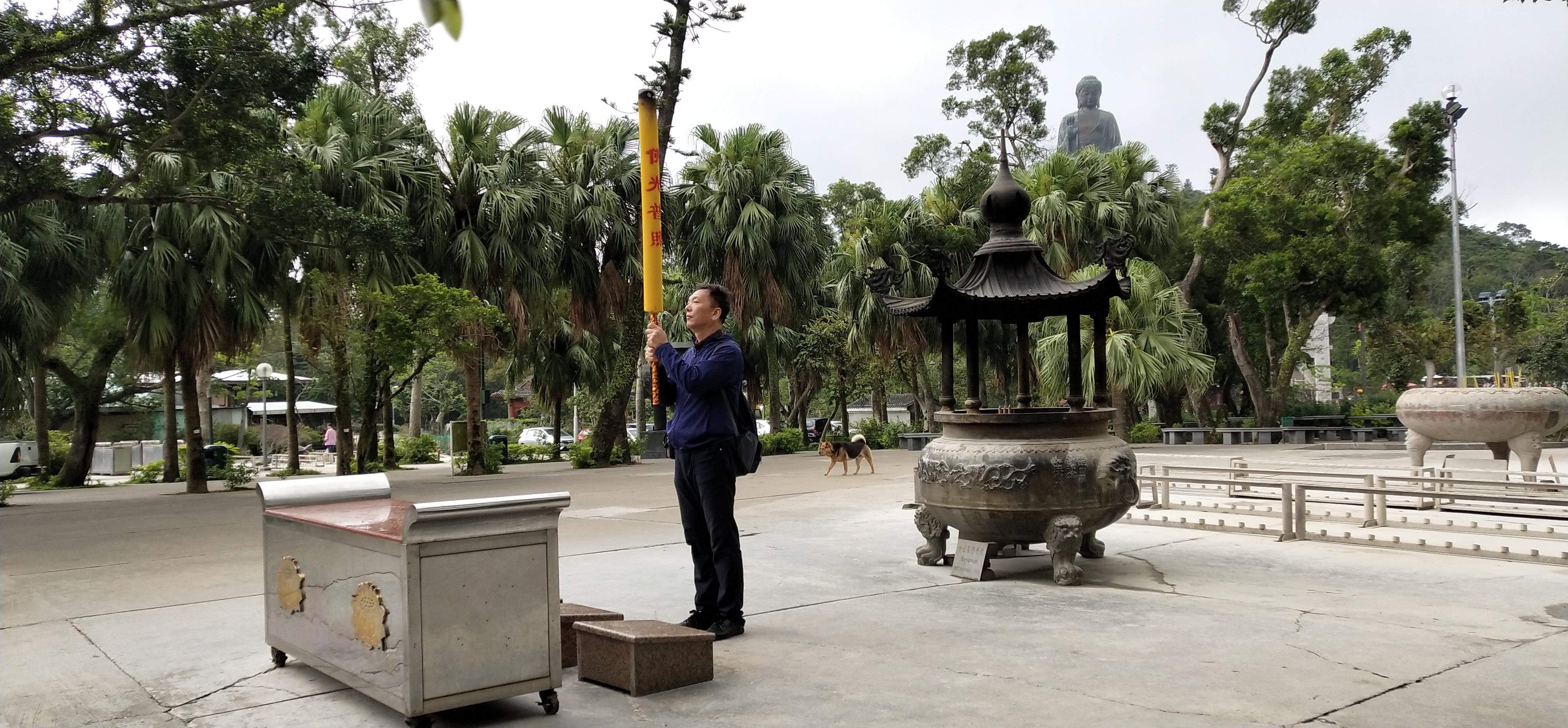 Worshipper is making wish with the long and big incense stick.