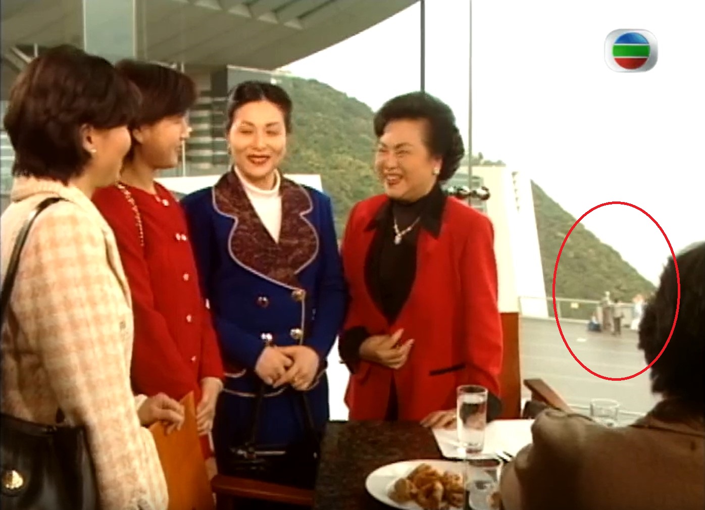 Screenshot of soap opera shows tourists at the old lookout point of the Peak Tower.