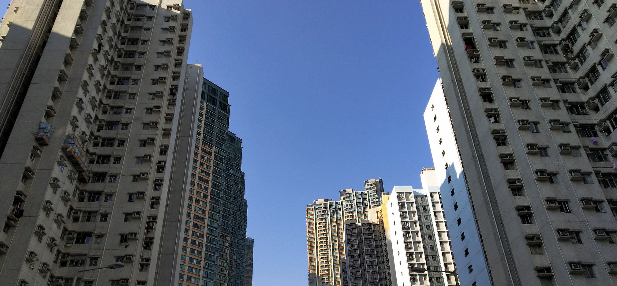 The super tall residential building wall blocks the sunlight.