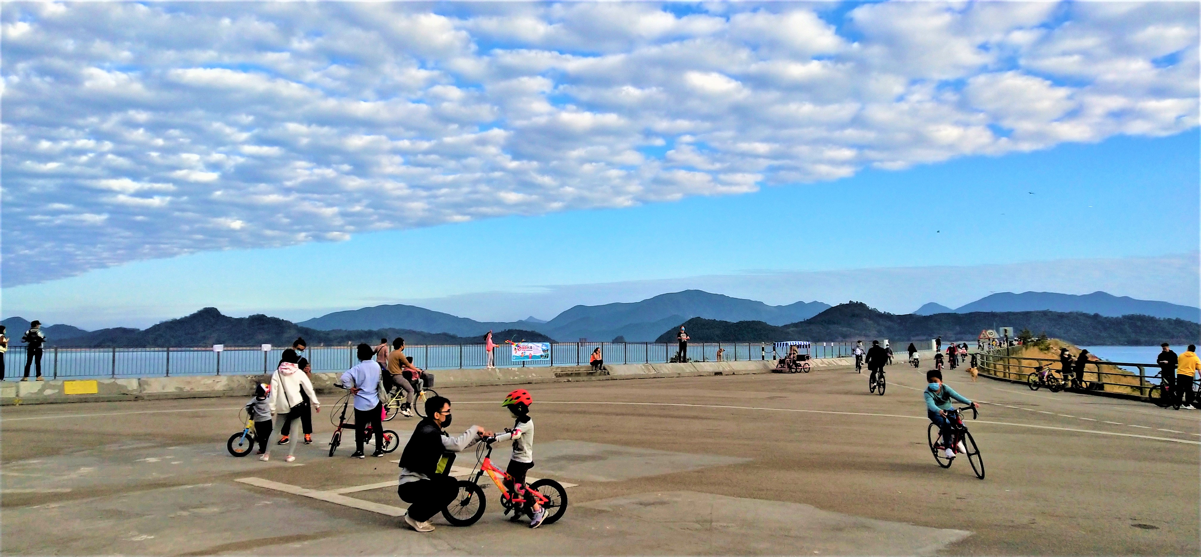 People can ride bicycle on the main dam of Plover Cove Reservoir