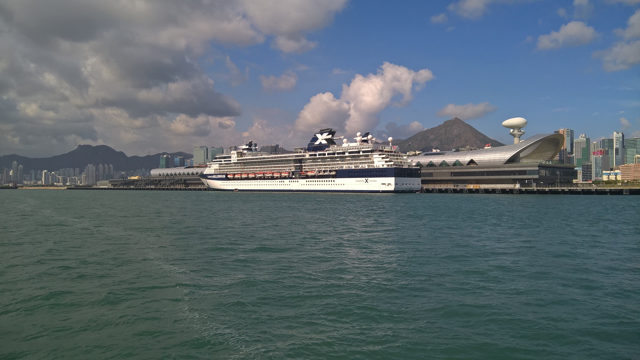 Photo taken from local ferry. Left to right, Lion Rock, Kai Tak Cruise Terminal, Kowloon Peak