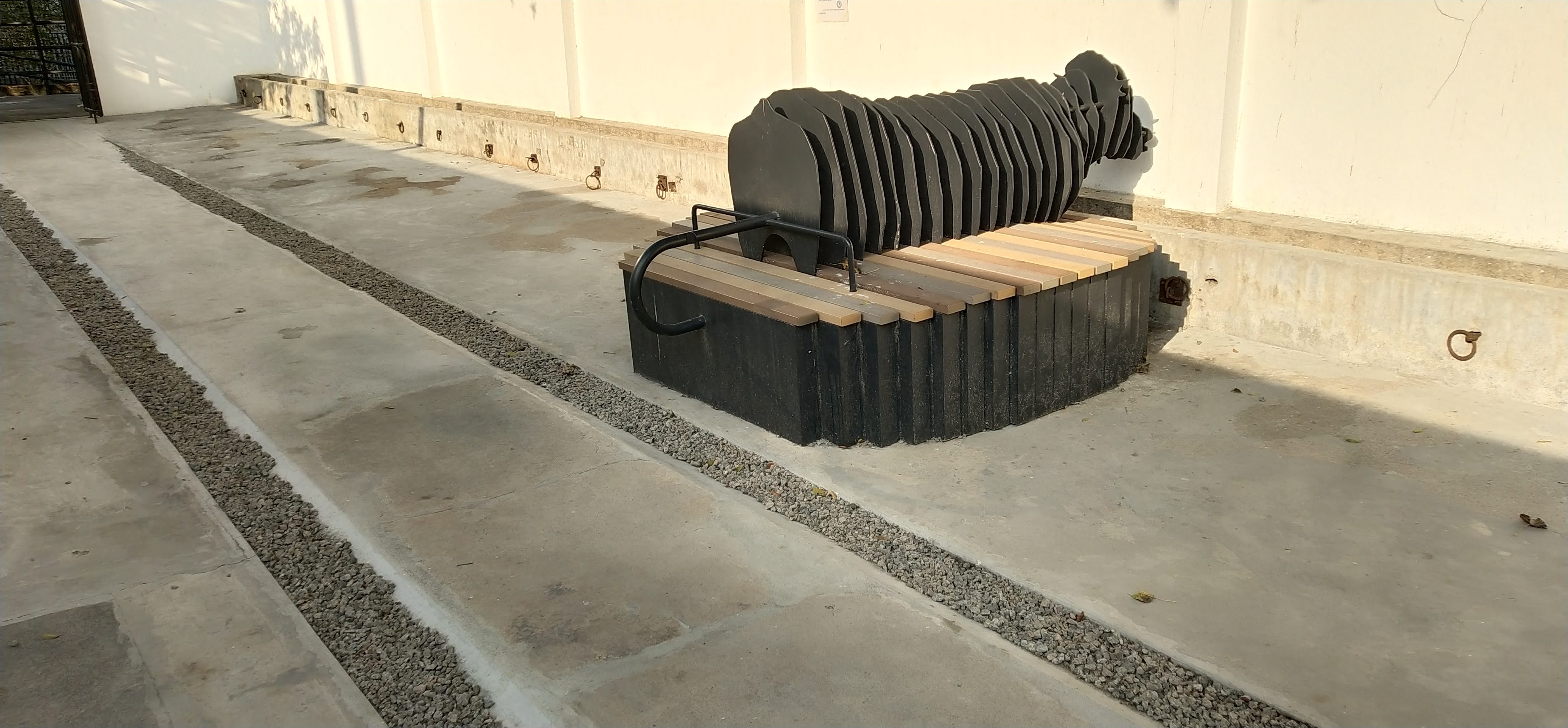 The bench in the park is the artwork, which shows the cattle is secured in the animal shed.