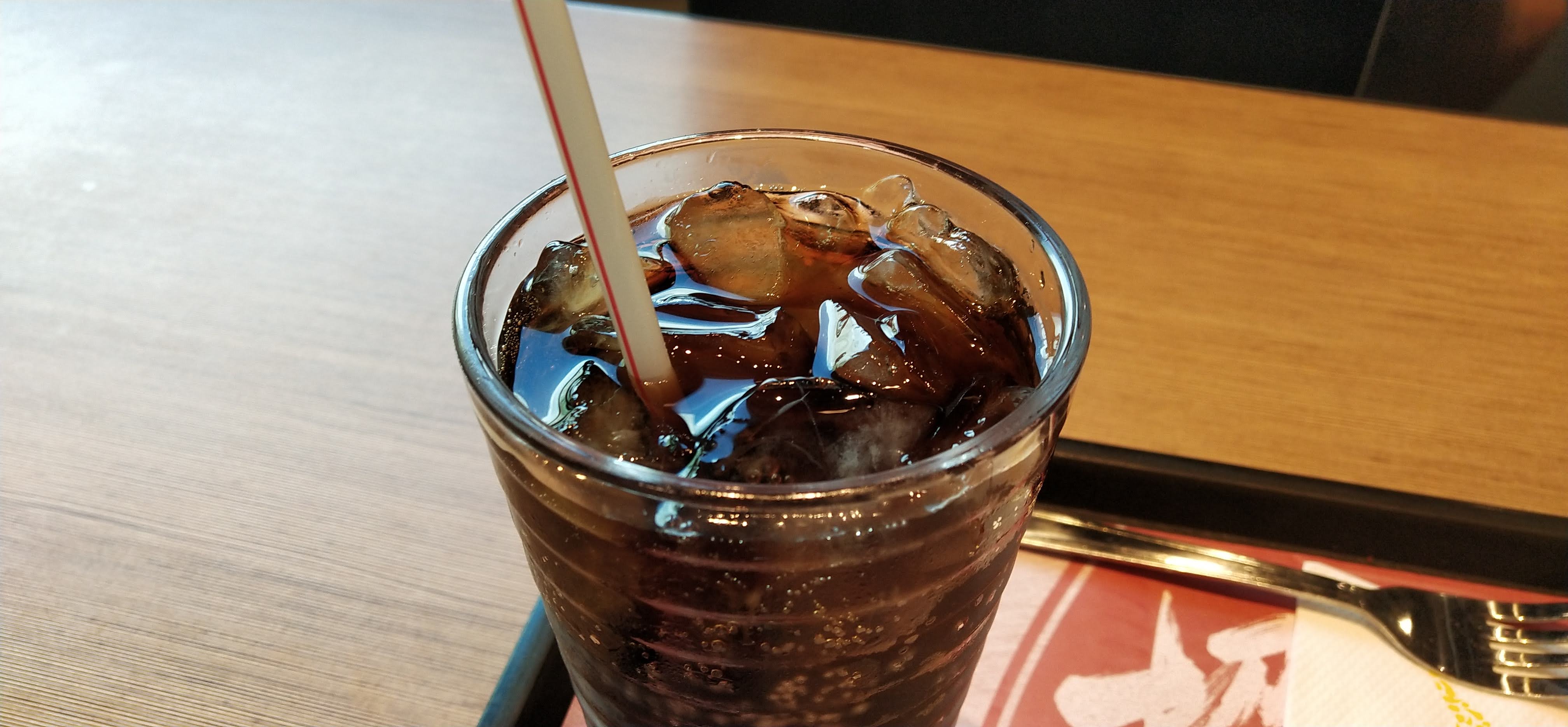 glass of Coca Cola, straw, ice