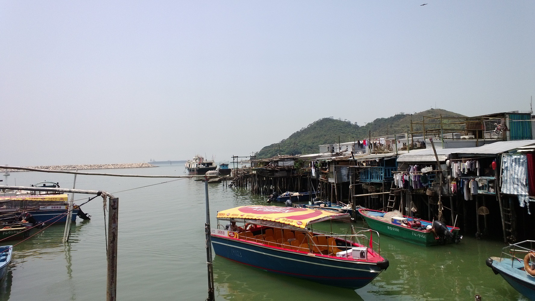 clear, sky, mountain, stilt houses, long fast boat