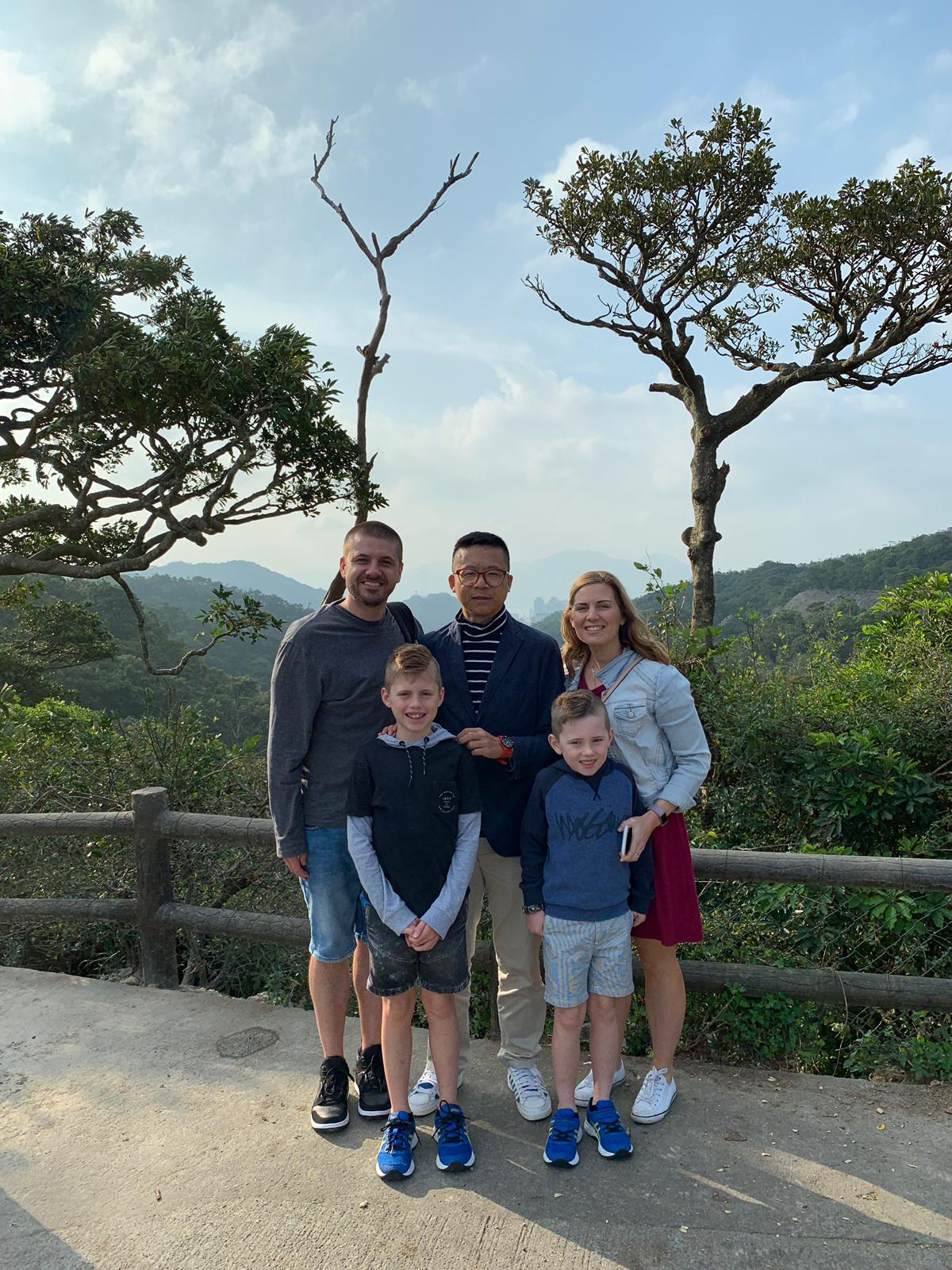 Frank the tour guide takes photo with a family client.Frank the tour guide takes photo with a family client.