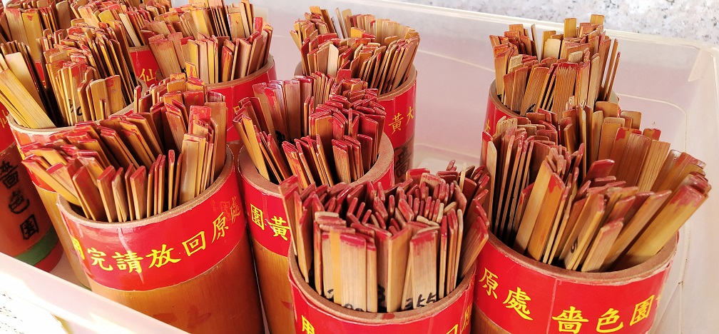 The 100 lucky sticks are inside the bamboo bucket.