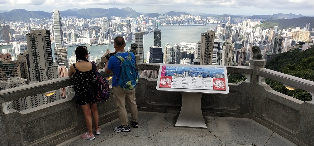 Travelers enjoy Victoria Harbor view at Victoria Peak.