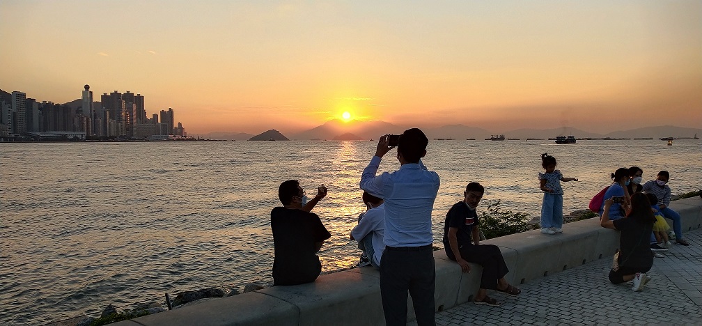 Locals enjoy sunset at West Kowloon Waterfront.