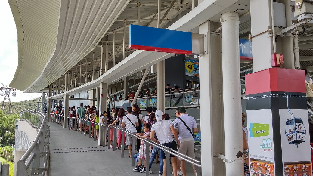 People waits for buying tickets at Tung Chung Ngong Ping 360 Cable Car Terminus. They still need to wait for the cable car cabin at the platform.
