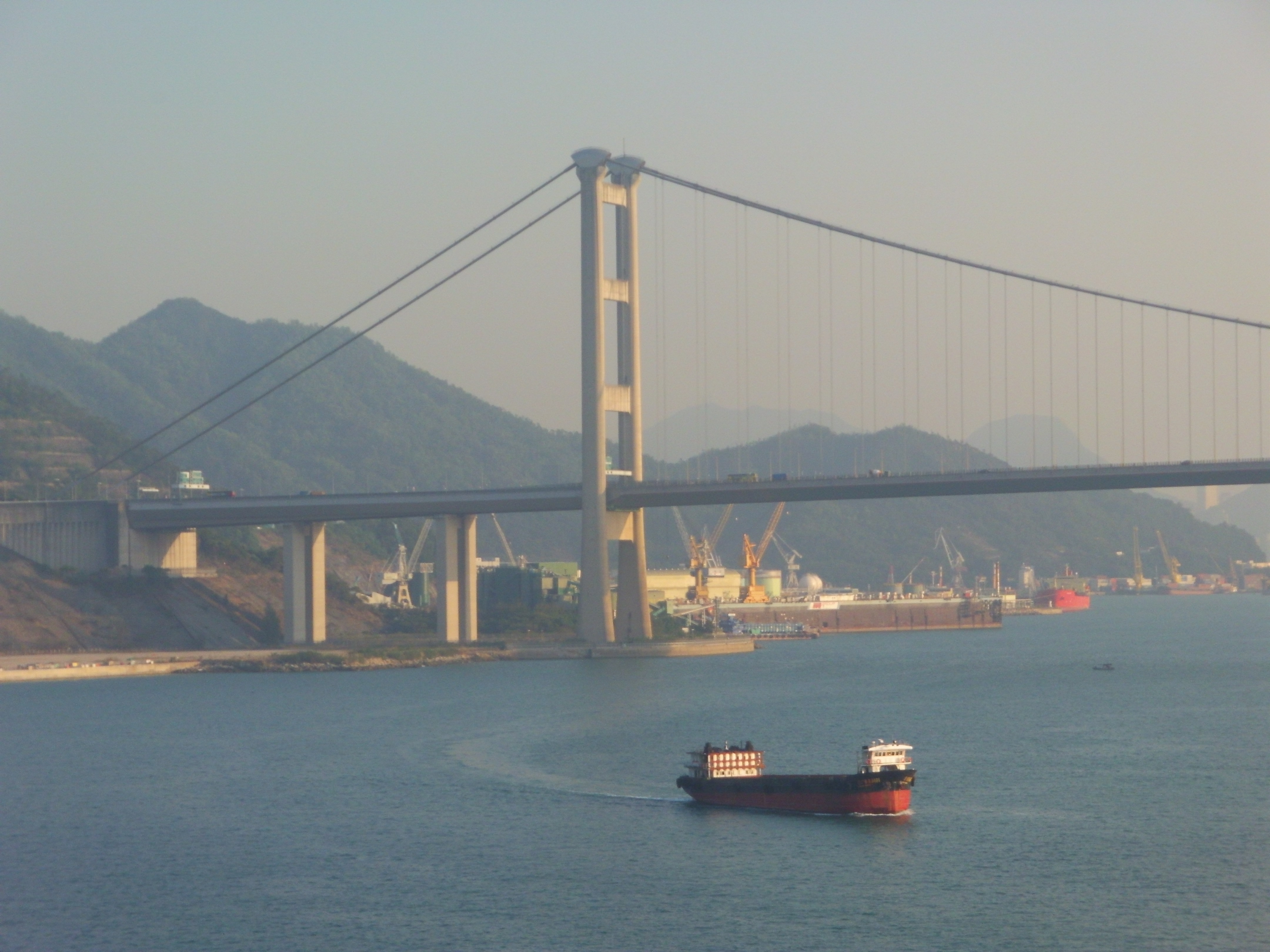 A barge just passes the sea under Tsing Ma Bridge