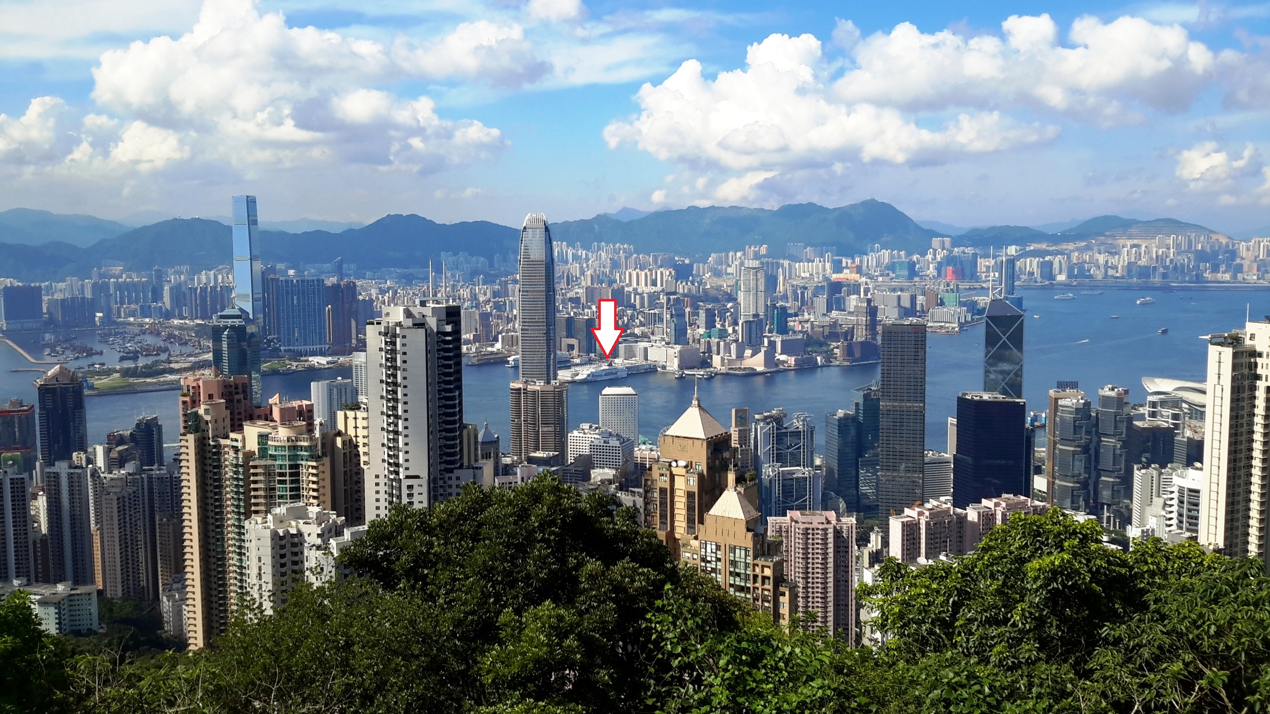 See cruise and Ocean Terminal (white arrow) at the Victoria Peak